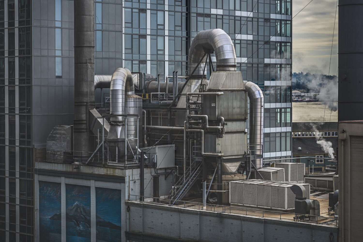 factory-surrounded-by-high-rise-buildings-with-greenery-scaled