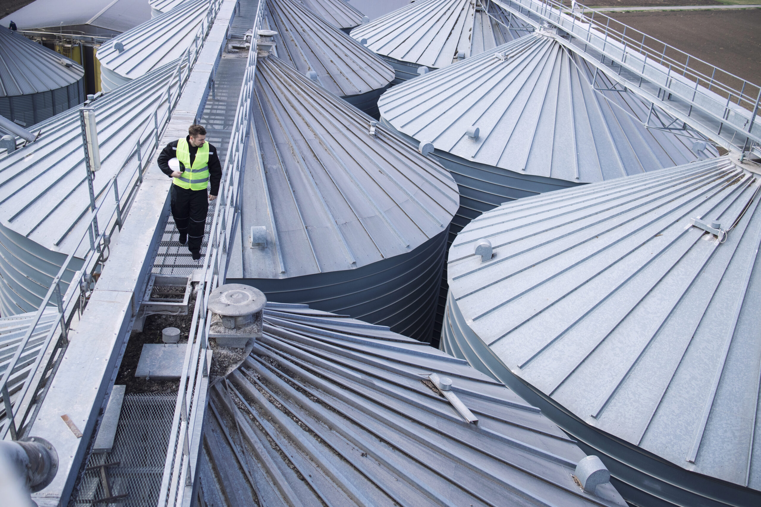Factory worker walking on metal platform
